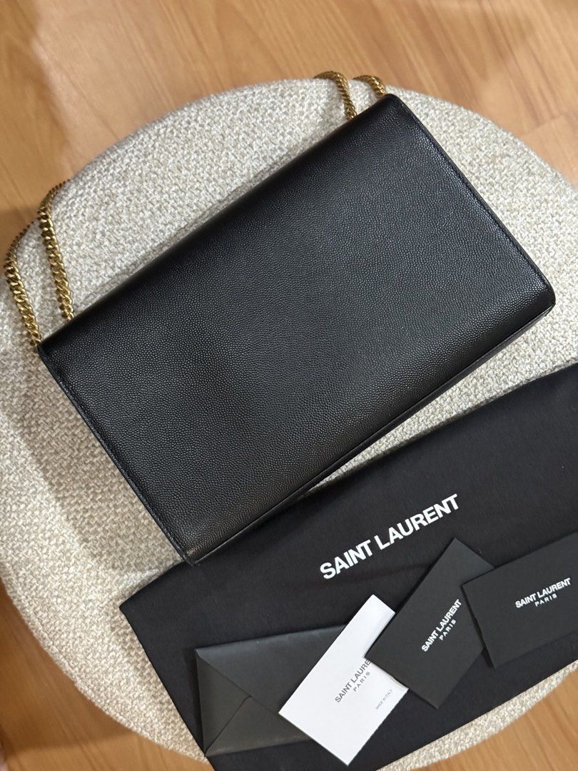 YSL Kate in medium (Category: Luxury Bags & Wallets) located in Quezon City. Submitted by happy_findds (Listing ID 1460438763, Image 3). Description: - Authentic pre loved Saint Laurent Kate in medium - Material: Black pebbled leather - Hardware: Gold-tone YSL logo - Condition: Great exterior, clean interior - Includes: Dust bag and authenticity cards - Strap: can wear crossbody or on shoulder o can be use as handbag.