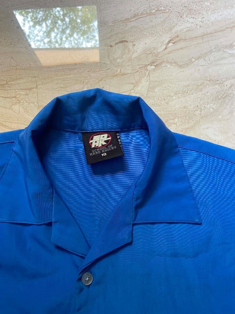 SCHOOL OF HARD KNOCKS Y2K POLO (Category: Tshirts & Polo Shirts ) located in Manila. Submitted by lilsintenel (Listing ID 1460399221, Image 3). Description: - Cool blue short sleeve button up shirt - 20x 27 - Features a fun graphic print on the front and back - Includes a convenient chest pocket - Ideal for casual everyday wear.