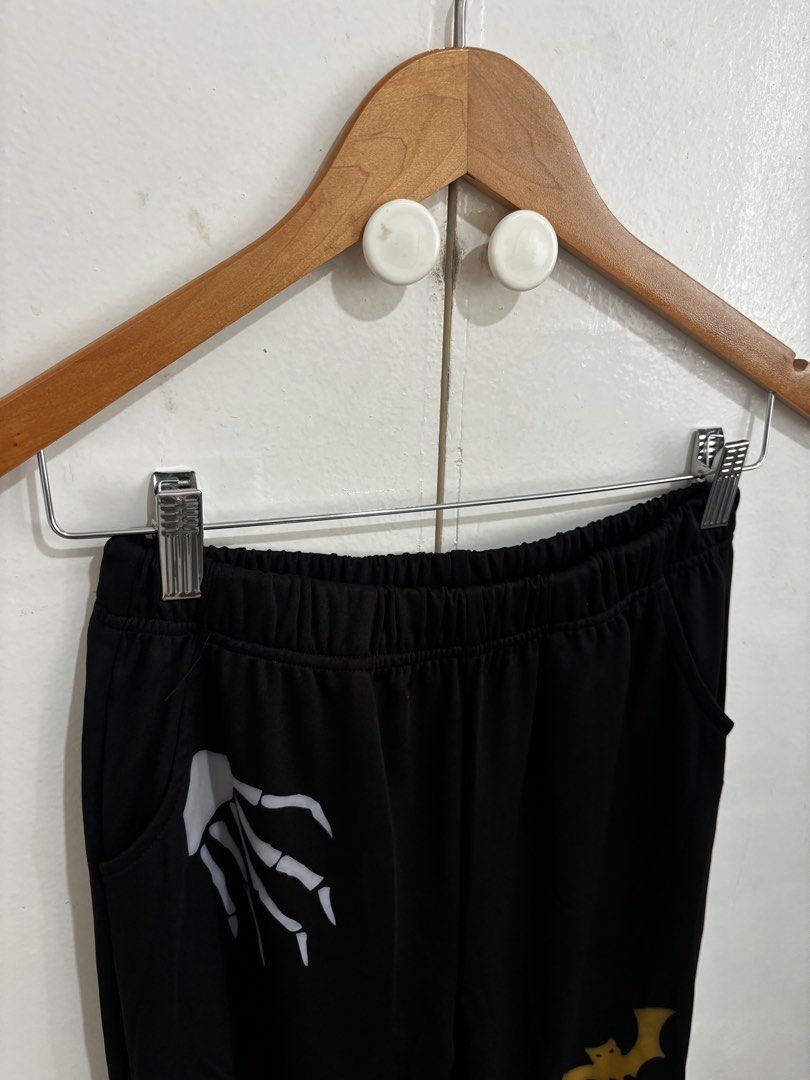 Shein Black Halloween Highwaist Flared Pants (Category: Other Bottoms) located in Manila. Submitted by dianafayesimbre (Listing ID 1460306802, Image 3). Description: - Black flared pants with fun Halloween prints - Designs include skeleton hands, melting skull, and bats - Comfortable elastic waistband - Flared leg for a stylish silhouette - Ideal for Halloween parties or adding a spooky touch to your everyday look - Size 15Y on tag but can fit sm