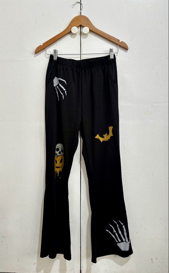 Shein Black Halloween Highwaist Flared Pants (Category: Other Bottoms) located in Manila. Submitted by dianafayesimbre (Listing ID 1460306802, Image 2). Description: - Black flared pants with fun Halloween prints - Designs include skeleton hands, melting skull, and bats - Comfortable elastic waistband - Flared leg for a stylish silhouette - Ideal for Halloween parties or adding a spooky touch to your everyday look - Size 15Y on tag but can fit sm