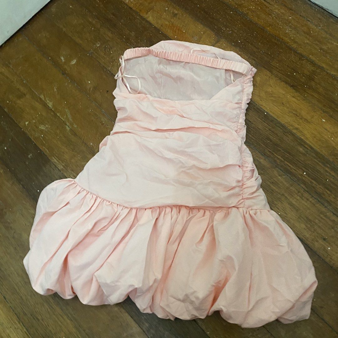 Shein Pink Ruched Strapless Bubble Hem Dress (Category: Dresses) located in Bacolor. Submitted by mxspicychicken (Listing ID 1460359350, Image 3). Description: Brand new! Never worn Xs-small - Adorable peachy pink strapless dress - Flattering ruching on the bodice - Fun and flirty bubble hem - Lightweight and flowy fabric for comfort - Includes a thin back strap (for adjustment or hanging) - Ideal for parties, dates, or a night out, birthday, gra