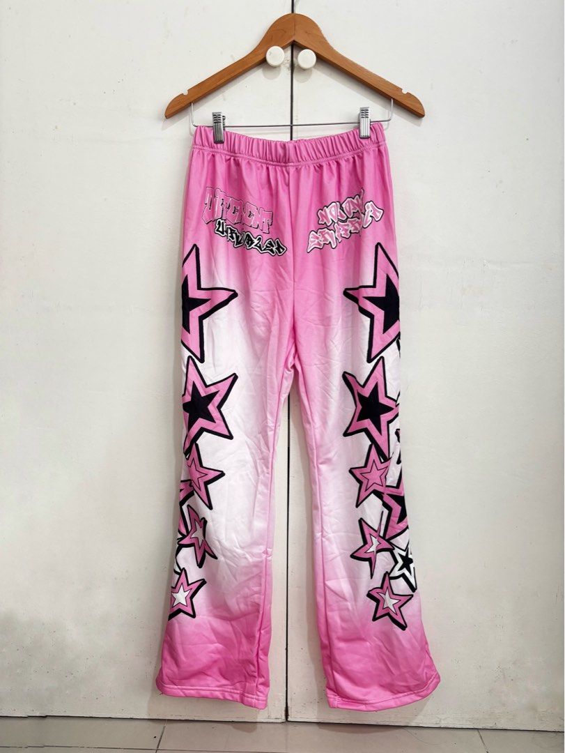 SHEIN Pink Star Print Flare Pants (Category: Jeans) located in Manila. Submitted by dianafayesimbre (Listing ID 1460366988, Image 1). Description: - Pink flare pants with black and white star print - Comfortable elastic waistband - Trendy streetwear style, perfect for casual outfits - Brand: SHEIN - Size: Teen 14Y but can fit small to large womens adult - Garterized waistline - Fits size 25-32 inches waistline - Length 40 inches.