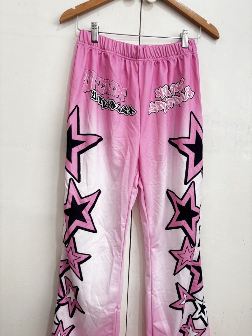 SHEIN Pink Star Print Flare Pants (Category: Jeans) located in Manila. Submitted by dianafayesimbre (Listing ID 1460366988, Image 3). Description: - Pink flare pants with black and white star print - Comfortable elastic waistband - Trendy streetwear style, perfect for casual outfits - Brand: SHEIN - Size: Teen 14Y but can fit small to large womens adult - Garterized waistline - Fits size 25-32 inches waistline - Length 40 inches.