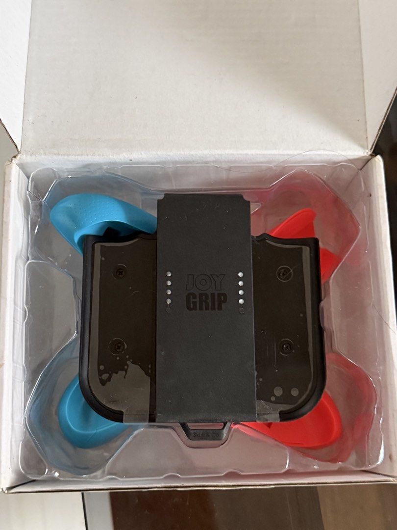 Skull & Co. Joy Grip for Nintendo Switch Neon Red & Blue (Category: Controllers) located in Manila. Submitted by carlaleyyydonato (Listing ID 1460396473, Image 2). Description: - Enhance handheld comfort with the Skull & Co. Joy Grip. - Designed for Neon Red & Blue Joy-Cons. - Makes extended gaming sessions more enjoyable. - Comes with original packaging. - All original parts included. Bought it for 2,100.