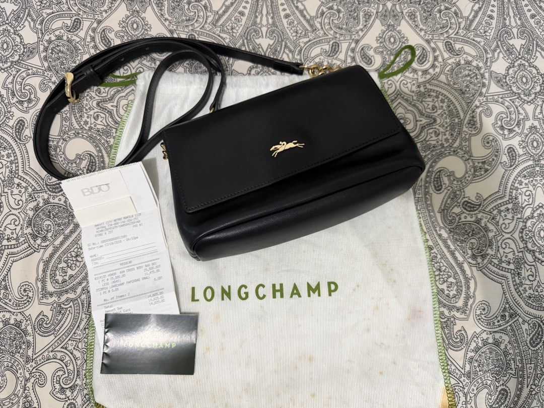 Sling bag (Category: Luxury Bags & Wallets) located in Muntinlupa City. Submitted by skapdesign (Listing ID 1460354767, Image 1). Description: Honore Longchamp’s signature horse and jockey hardware adorns this elegantly streamlined flap front crossbody in supple leather. Features Preloved Adjustable crossbody strap Magnetic flap closure; lined Two interior zip pockets 8.5”W x 3”D x 6”H; 25” strap drop Leather Clean in & out.