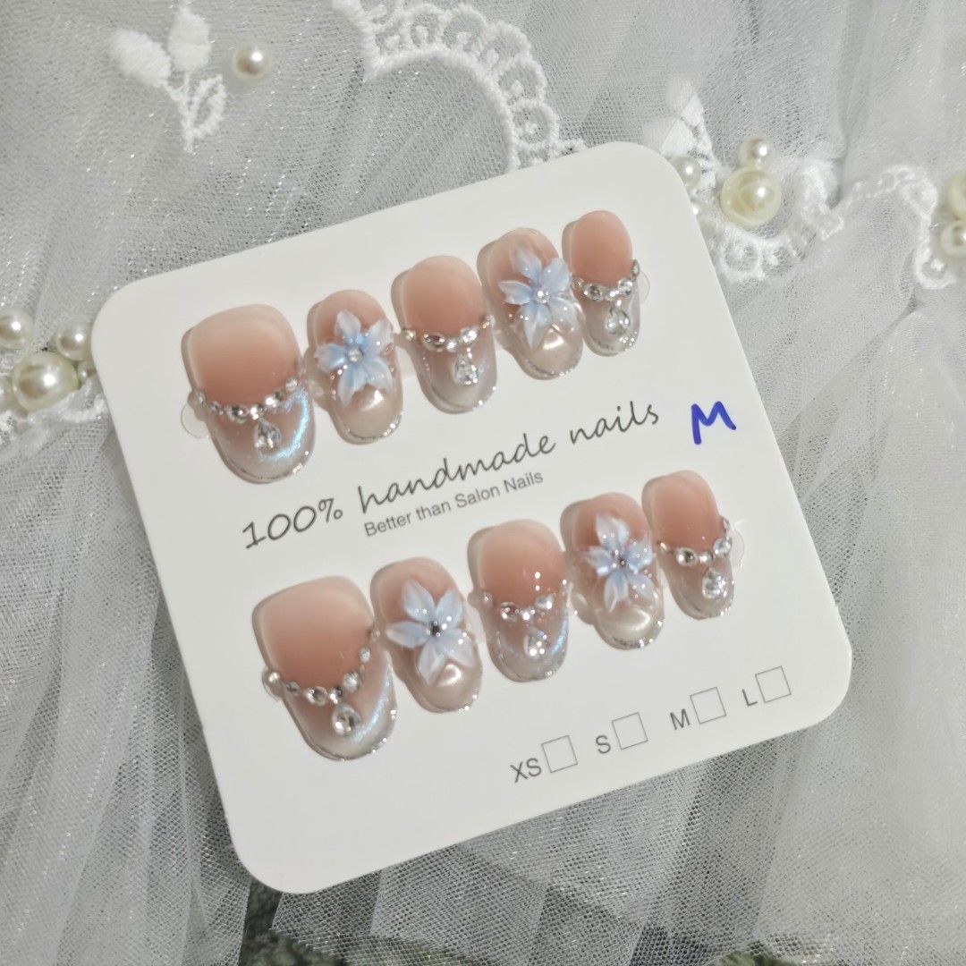 MEDIUM Short Oval 100% Handmade Nails with Flower & Rhinestone Design (Category: Hands & Nails) located in Makati City. Submitted by jangmiscloset (Listing ID 1460322185, Image 1). Description: Double the glam, get a bonus! Buy any 2 sets (₱200 and up ) and receive a ₱100 nail set FREE. Mix & match your faves and enjoy more styles without spending extra ✨- Adorable handmade press-on nails - Soft pink base with delicate blue flowers - Sparkling rh