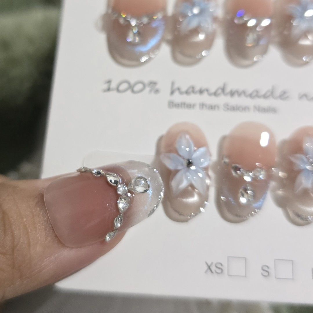 MEDIUM Short Oval 100% Handmade Nails with Flower & Rhinestone Design (Category: Hands & Nails) located in Makati City. Submitted by jangmiscloset (Listing ID 1460322185, Image 3). Description: Double the glam, get a bonus! Buy any 2 sets (₱200 and up ) and receive a ₱100 nail set FREE. Mix & match your faves and enjoy more styles without spending extra ✨- Adorable handmade press-on nails - Soft pink base with delicate blue flowers - Sparkling rh