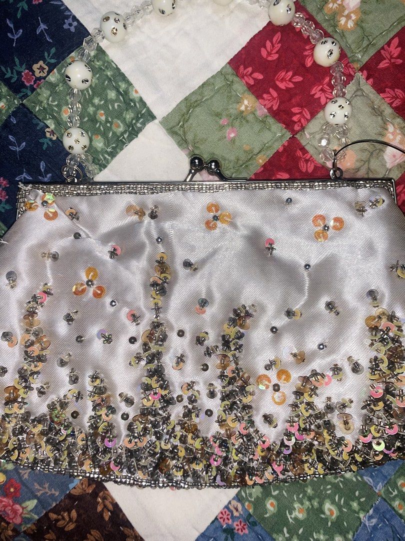 Sparkly Beaded Handle Clutch Bag with Sequins (Category: Clutches) located in Dagupan City. Submitted by sj_styles0910. (Listing ID 1460470649, Image 2). Description: - White satin clutch bag -with sling - Covered in shimmering sequins and delicate flower details - Features a beautiful beaded handle with clear and white beads - Secure clasp closure at the top - Ideal for parties, weddings, and special occasions - Measures approximately 8 inches w