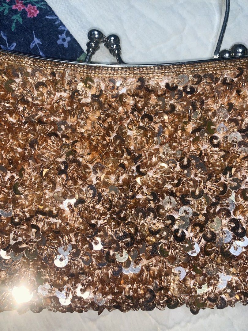 Sparkly Rose Gold Sequin Clutch Evening Bag (Category: Clutches) located in Dagupan City. Submitted by sj_styles0910. (Listing ID 1460469913, Image 2). Description: - Rose gold sequin clutch - Features a metal frame and ring handle - Secure metal clasp closure - Ideal for parties and special occasions - Adds sparkle and glamour to any outfit.
