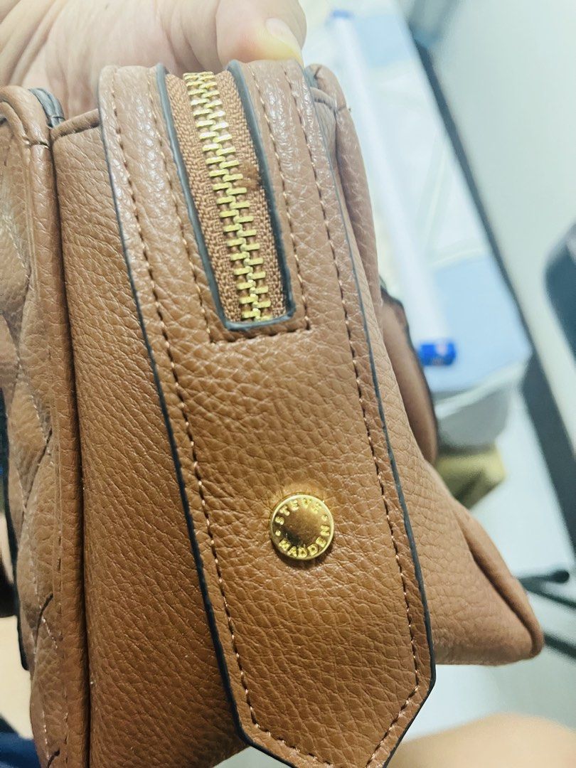Steve Madden Quilted Brown Handbag (Category: Luxury Bags & Wallets) located in Manila. Submitted by vineshrubs75 (Listing ID 1460323667, Image 2). Description: - Authentic Steve Madden brown quilted handbag - Front pocket for easy access - Secure zip-top closure - Spacious interior to fit your essentials - Elegant gold hardware details - Give this beautiful bag a new home!.