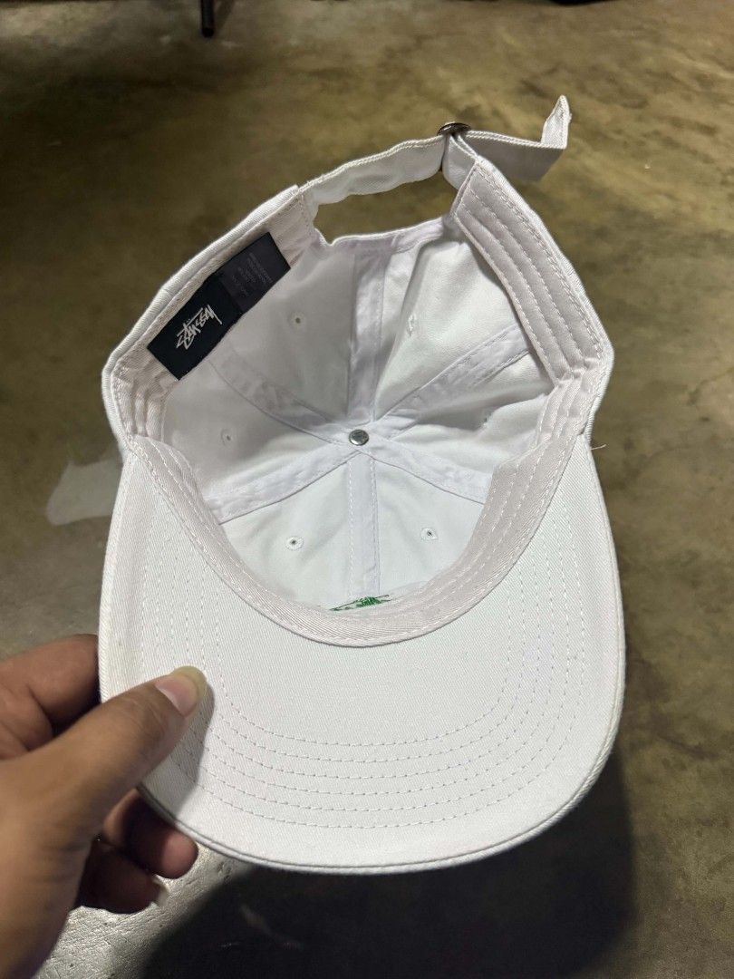 Stussy Cap White Cotton OSFM (Category: Caps & Hats) located in Manila. Submitted by thriftyboyzzz (Listing ID 1460468210, Image 2). Description: - Classic white Stussy dad cap - Embroidered green Stussy logo on front - Made from 100% cotton - Adjustable strap for a comfortable fit - Ideal for everyday casual wear.