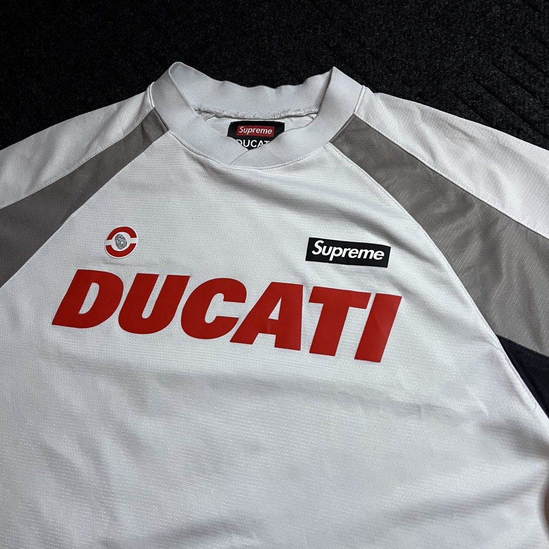 Supeme X Ducati Socce Jersey (Category: Tshirts & Polo Shirts ) located in Davao. Submitted by archived.status (Listing ID 1460483233, Image 1). Description: COLOR MAY VARY DUE TO LIGHTING‼️ Condition: 9.5/10 Color rate: 9.5/10, or better Issue: minimal stain for safe as white, and pinhole repairable see last pic Size Medium fit Large Width 22 Length 28.