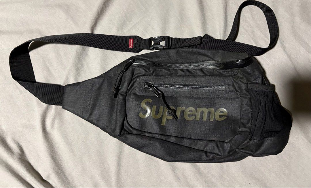 Supreme Waist Bag Black (Category: Luxury Bags & Wallets) located in Lubao. Submitted by kur_tt (Listing ID 1460473395, Image 1). Description: - Authentic Black Supreme Waist Bag - Iconic Supreme logo on the front - Multiple zippered compartments for secure storage - Adjustable strap with buckle closure for a comfortable fit - Convenient side mesh pocket - Ideal for everyday use, travel, or festivals.