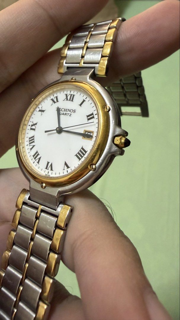 Technos Quartz Two-Tone Watch with Date (Cartier inspired) (Category: Men's Watches) located in Cebu City. Submitted by ronhern (Listing ID 1460382764, Image 3). Description: - Technos Quartz vintage watch - Two-tone stainless steel band with gold accents (cartier inspired) - Classic white dial with Roman numerals - Convenient date window at 3 o'clock - Water resistant *negotiable *bought from a 2nd hand vintage watch seller *see images for signs