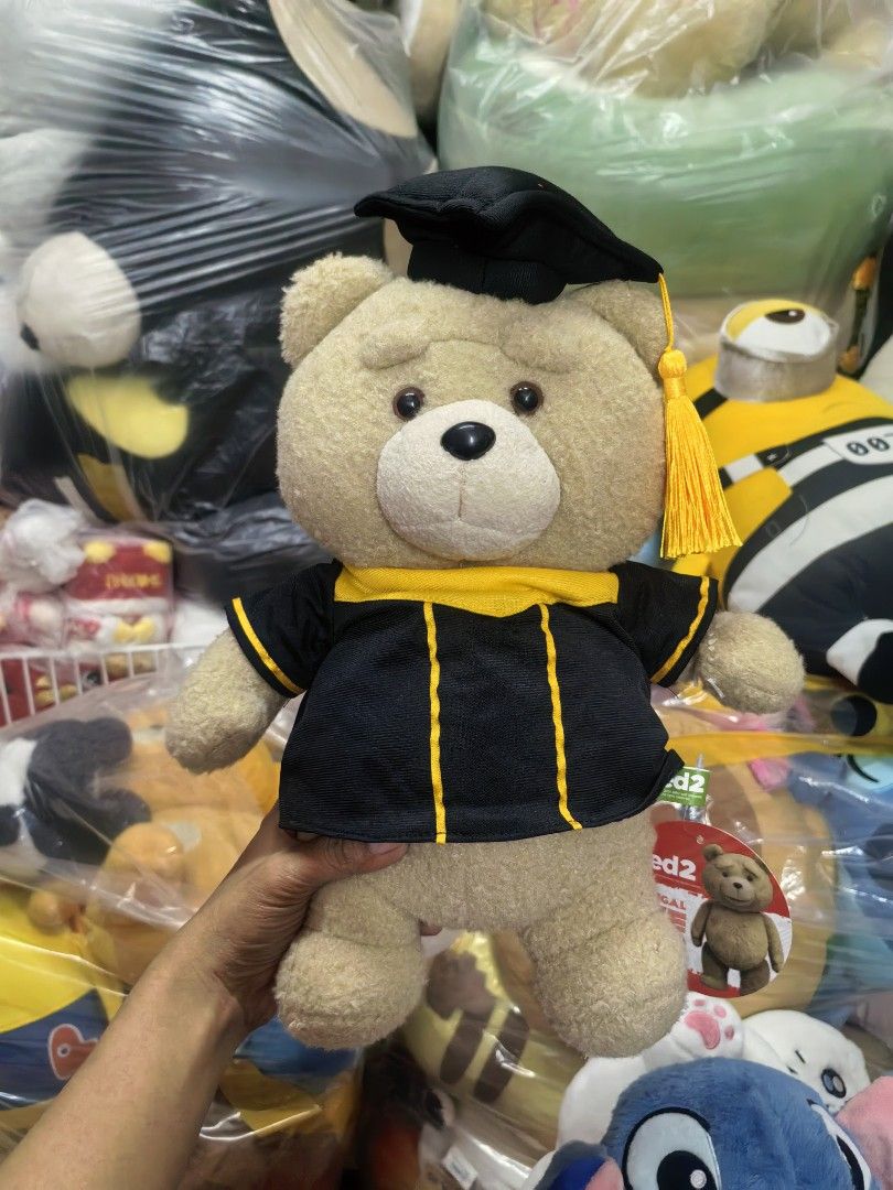 Ted 2 Graduation Teddy Bear Plush Toy Approx 35cm (Category: Plushies & Soft Toys) located in Paranaque City. Submitted by furugiyafinds (Listing ID 1460480321, Image 1). Description: - Adorable Ted 2 plush toy - Comes with a graduation cap and gown - Approximately 10 inches tall - Soft and cuddly material - Ideal gift for Ted fans or as a graduation present - Brand new with tag still attached.