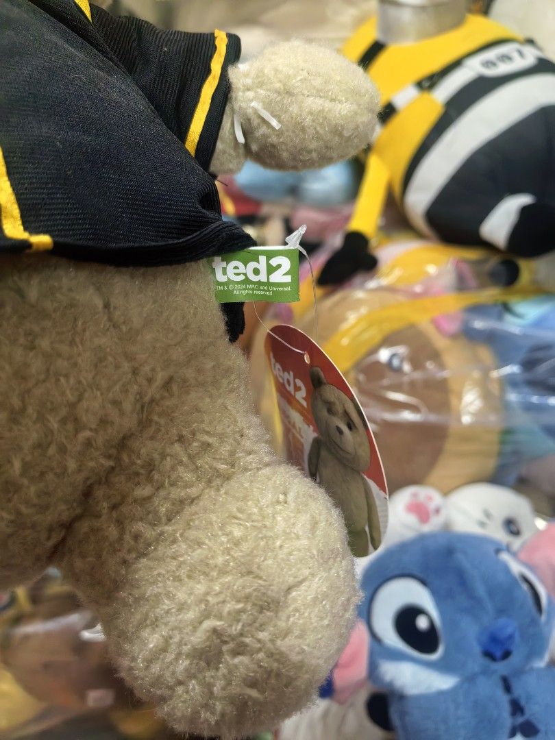 Ted 2 Graduation Teddy Bear Plush Toy Approx 35cm (Category: Plushies & Soft Toys) located in Paranaque City. Submitted by furugiyafinds (Listing ID 1460480321, Image 2). Description: - Adorable Ted 2 plush toy - Comes with a graduation cap and gown - Approximately 10 inches tall - Soft and cuddly material - Ideal gift for Ted fans or as a graduation present - Brand new with tag still attached.