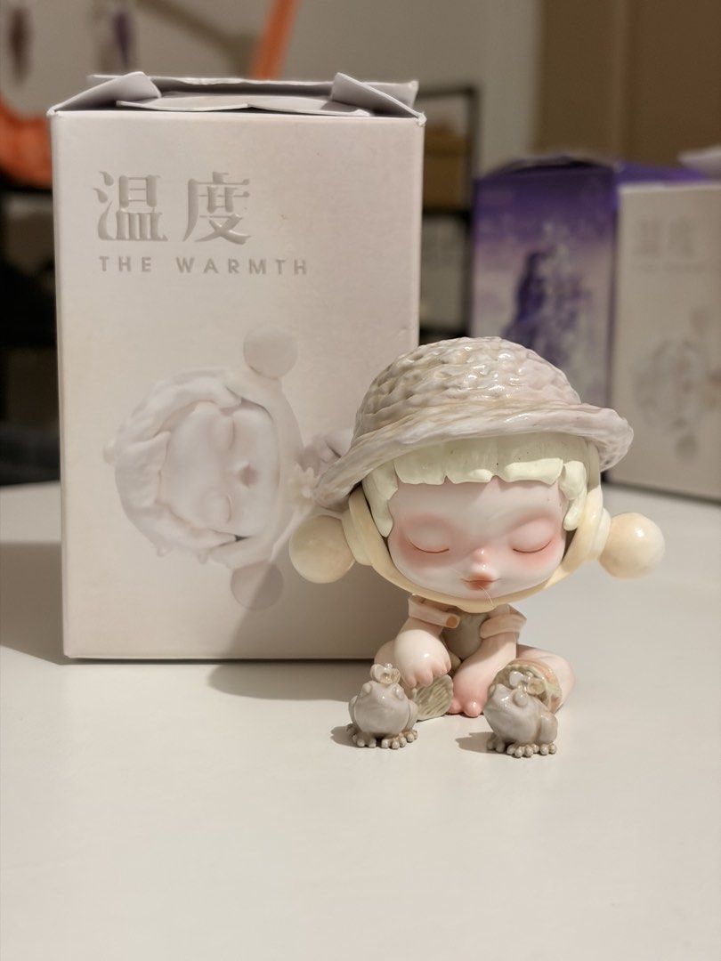 Skullpanda The Warmth Series (Category: Designer & Blind Box Toys) located in Manila. Submitted by aubreyours07 (Listing ID 1460479864, Image 1). Description: - Includes original box - Sweet, sleepy expression - Comes with two little frog companions - Box features Chinese characters and 'THE WARMTH' branding - Perfect collectible item.
