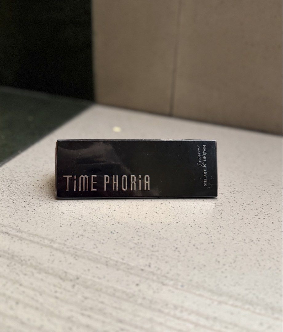 TIME PHORIA Stellar Dust Lip Stain Enigma 09 (Category: Makeup) located in Manila. Submitted by mcpascua (Listing ID 1460335665, Image 1). Description: - TIME PHORIA Stellar Dust Lip Stain - Shade: Enigma 09 (Deep Red) - Brand New & Sealed Packaging - Achieve a bold lip look.