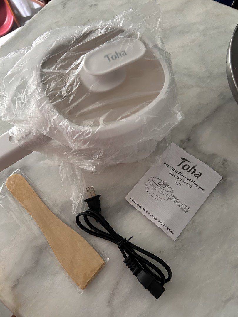 Toha Multi-function Cooking Pot TF01 with Accessories (Category: Cookware & Accessories) located in Manila. Submitted by alisondzi (Listing ID 1460472695, Image 2). Description: ✅ White Toha Multi-Function Cooking Pot (Model TF01) Includes: Pot, Lid, Wooden Spatula, Power Cord, User Manual ✅ Ideal for small kitchens and dorm rooms ✅ Easy to operate and maintain ✅ Simple to clean Never been used, opened for photos only. Selling it because this was