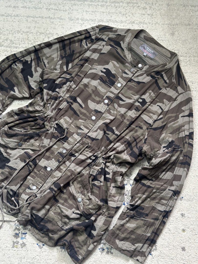 Torrid Green Camouflage Lightweight Utility Anorak Jacket (Category: Coats, Jackets and Outerwear) located in Daet. Submitted by thrifthings2018 (Listing ID 1460343892, Image 2). Description: - Torrid green camouflage utility/anorak jacket - Lightweight material - Adjustable drawstring waist - Button front closure - Two front pockets - Measurements: Width 28 inches, Length 33 inches - Ideal for casual wear.