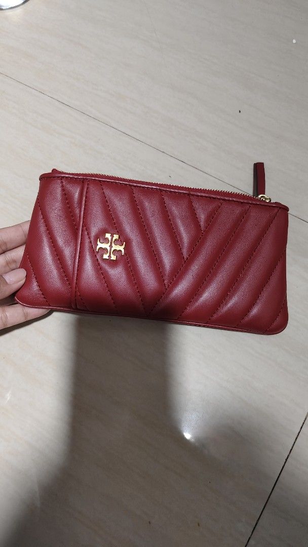 Tory Burch Red Quilted Leather Pouch (Category: Purses & Pouches) located in Antipolo. Submitted by robannrave98496 (Listing ID 1460355490, Image 1). Description: - Tory Burch red quilted leather pouch - Gold zipper closure - Interior card slots - Small wrist strap attached - Ideal for organizing essentials or as a clutch.