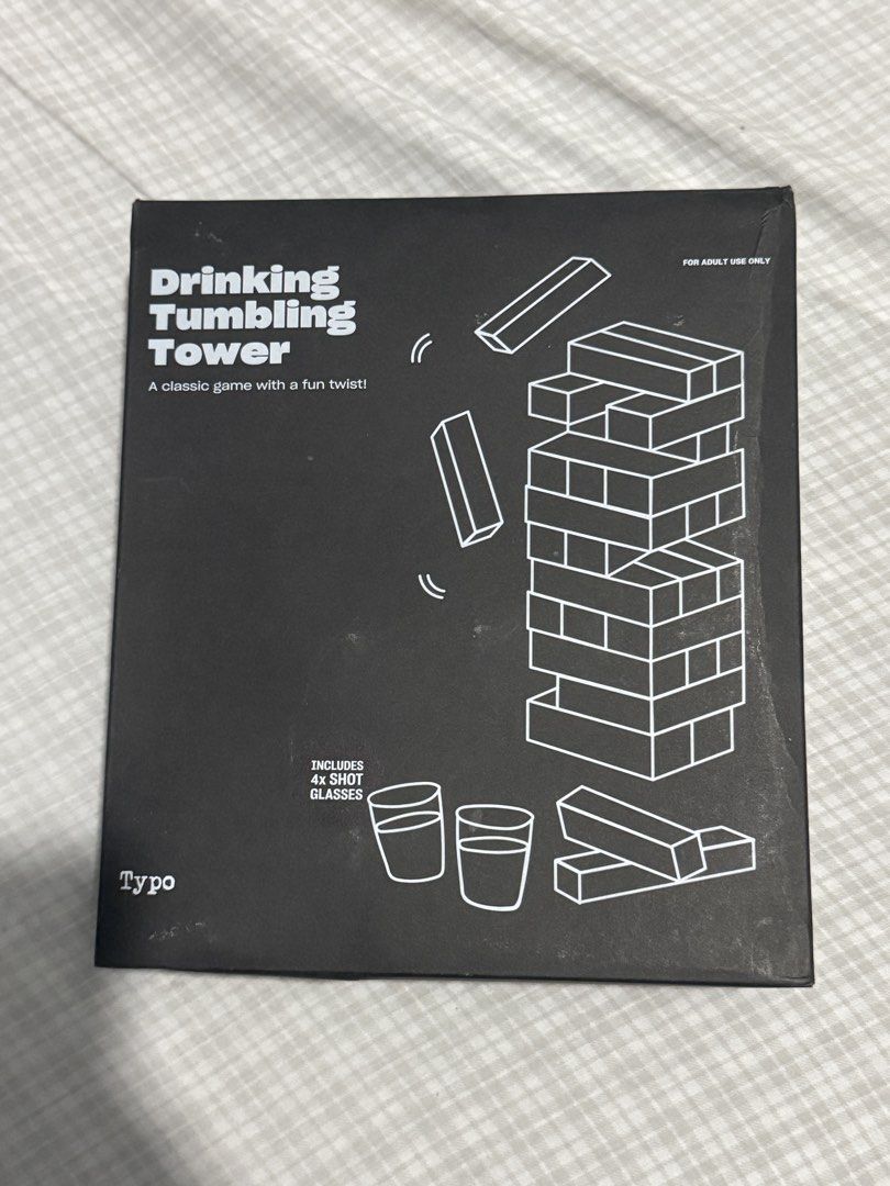 Typo Drinking Tumbling Tower (Category: Other Kitchenware & Tableware) located in Iloilo. Submitted by qwertrisha (Listing ID 1460425676, Image 1). Description: - Classic tumbling tower game with a fun drinking twist. - Comes with 4 shot glasses featuring 'DRINK UP' print. - Ideal for parties and gatherings. - Enjoy a fun game night with friends..