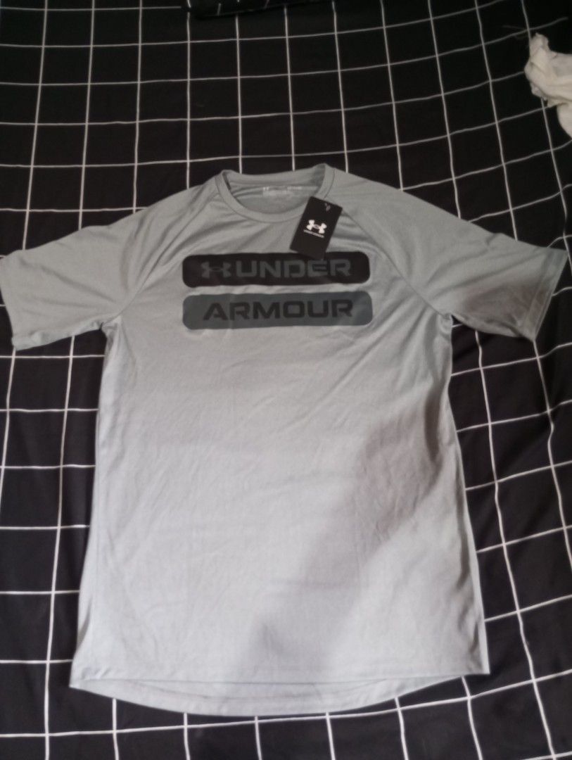 Under Armour Grey T-shirt (Category: Tshirts & Polo Shirts ) located in Imus. Submitted by wreckitralph_ (Listing ID 1460361565, Image 1). Description: - Grey Under Armour t-shirt - Short sleeves - UA logo printed on front - Brand new with tags - Ideal for sports or casual wear.