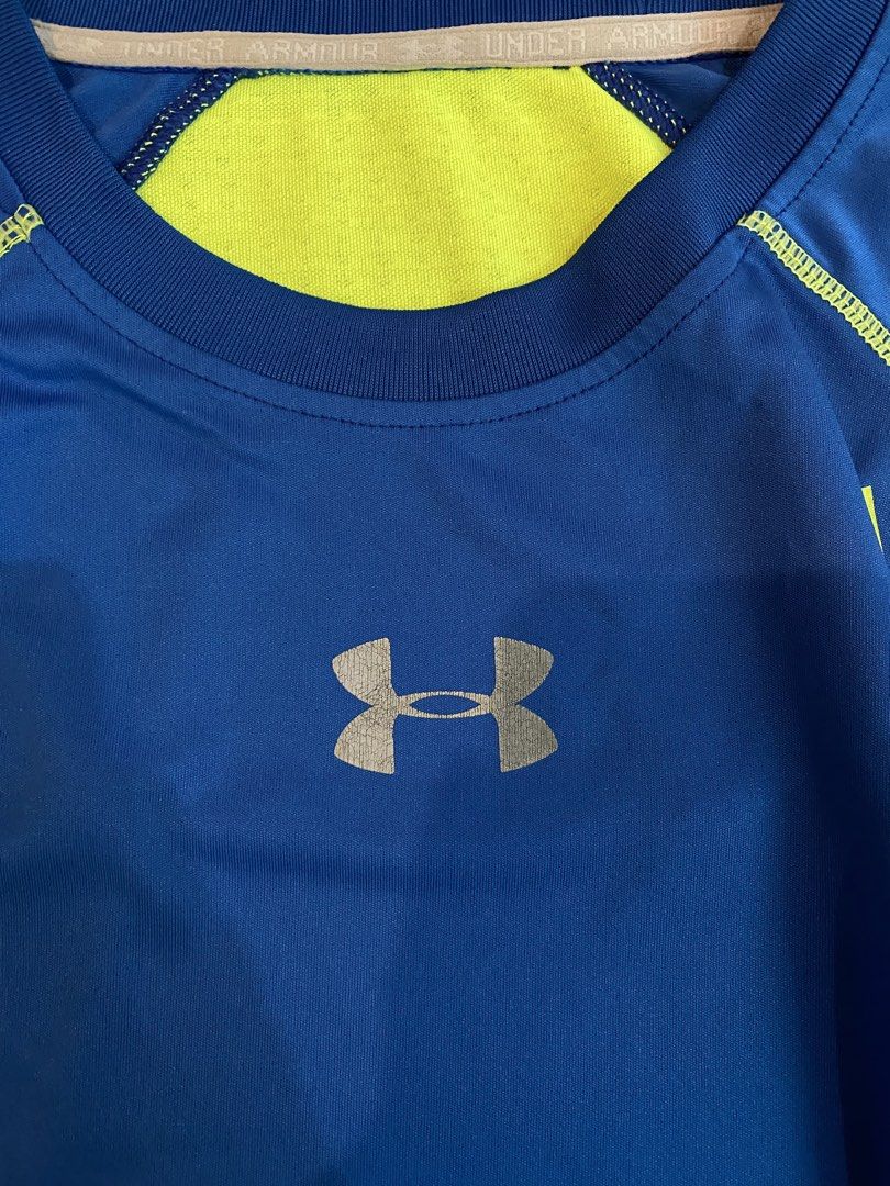 Under Armour Long Sleeve Athletic Shirt (Category: Tshirts & Polo Shirts ) located in Manila. Submitted by sebthrift (Listing ID 1460359927, Image 3). Description: - Blue and neon yellow Under Armour long sleeve shirt - Great for sports, workouts, running, or training - Breathable material for comfort - Features Under Armour logo on the front - Back design includes mesh panels for ventilation.