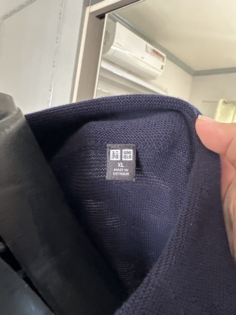 Uniqlo Collared Knit Polo Shirt (Category: Tshirts & Polo Shirts ) located in Caloocan City. Submitted by 4mscloset (Listing ID 1460358061, Image 2). Description: - Navy blue knit polo shirt - Short sleeves - Classic collar with a deep V-neck opening - Subtle ribbed texture - Versatile for casual or smart-casual looks - Pairs well with jeans or shorts.