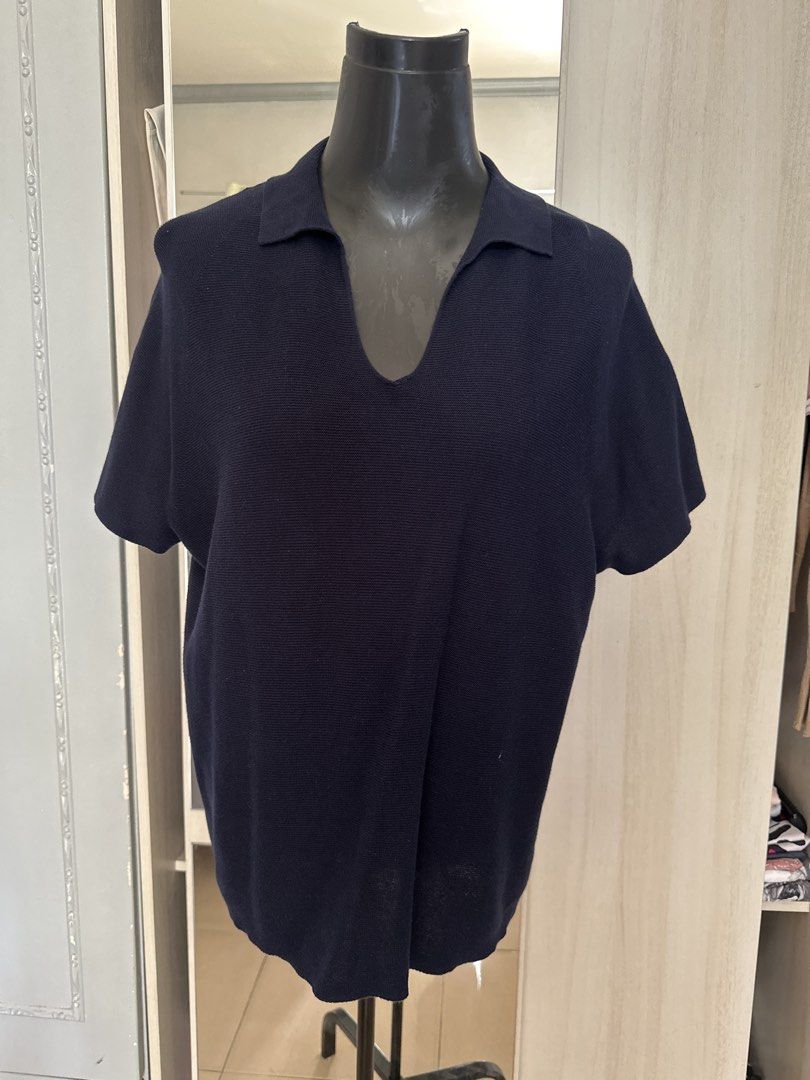 Uniqlo Collared Knit Polo Shirt (Category: Tshirts & Polo Shirts ) located in Caloocan City. Submitted by 4mscloset (Listing ID 1460358061, Image 1). Description: - Navy blue knit polo shirt - Short sleeves - Classic collar with a deep V-neck opening - Subtle ribbed texture - Versatile for casual or smart-casual looks - Pairs well with jeans or shorts.
