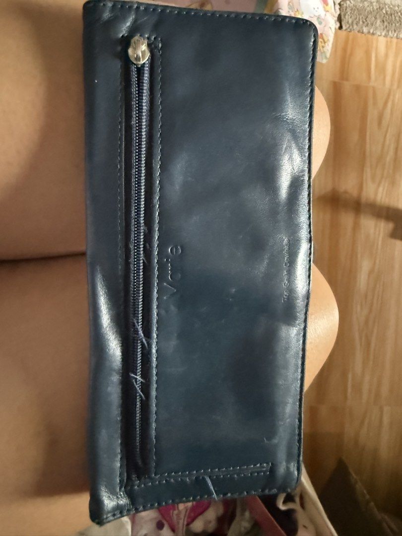 Vance Genuine Leather Wallet (Category: Wallets & Card holders) located in Taguig. Submitted by ayieabolencia (Listing ID 1460459690, Image 1). Description: - Dark blue Vance wallet - Genuine leather - Front zippered coin pocket - Note: Some stitching on the zipper is coming undone - Ample space for cards and cash - Classic design, perfect for everyday use.
