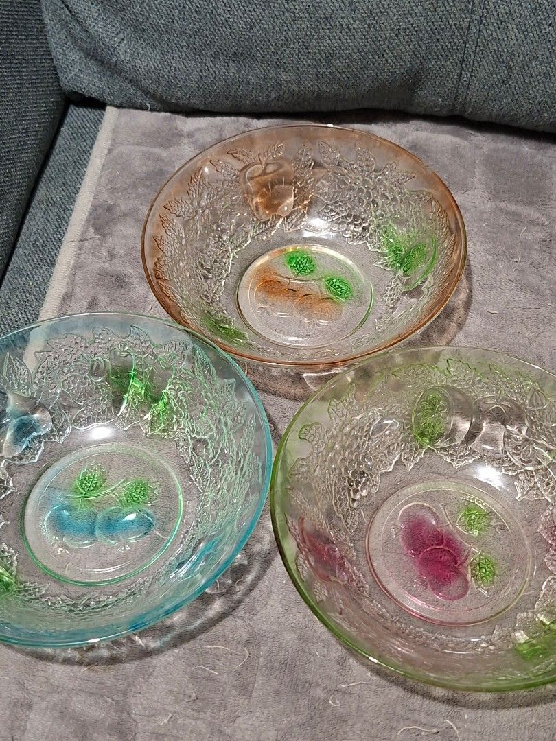 Vintage Glass Fruit Embossed Bowls Set (Category: Dinnerware & Cutlery) located in Taguig. Submitted by thrift_outlet.taguig (Listing ID 1460469365, Image 1). Description: 3 Kig Indonesia Colorful bowls 7 inches width - Set of unique vintage glass bowls - Features charming fruit and leaf imprints - Accents in green, blue, and pinkish-orange - Ideal for serving snacks or as decorative pieces - Sold as a complete set.