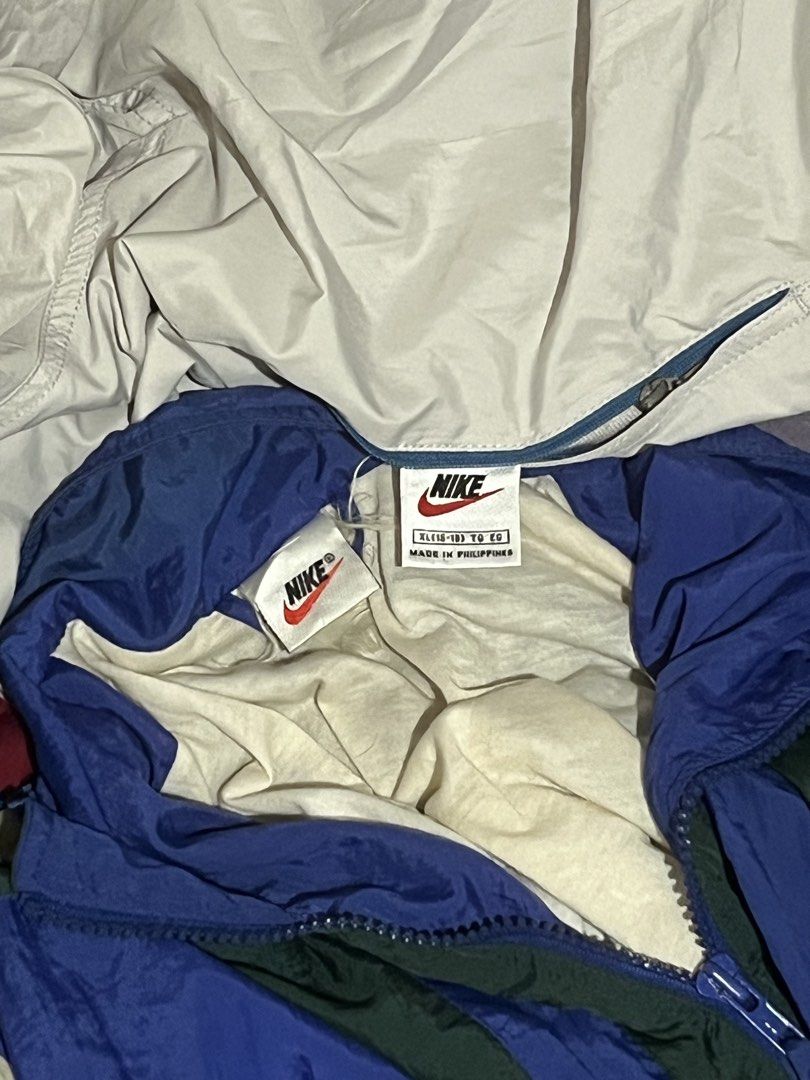 Vintage Nike Windbreaker Track Jacket (Category: Coats, Jackets and Outerwear) located in Manila. Submitted by jelooo_29 (Listing ID 1460337132, Image 3). Description: - Two vintage Nike windbreakers included. - Color 1: Blue, white, and red. - Color 2: Blue, green, and cream. - Both feature the iconic Nike logo. - Perfect for casual wear or athletic activities. - Both are size XL..