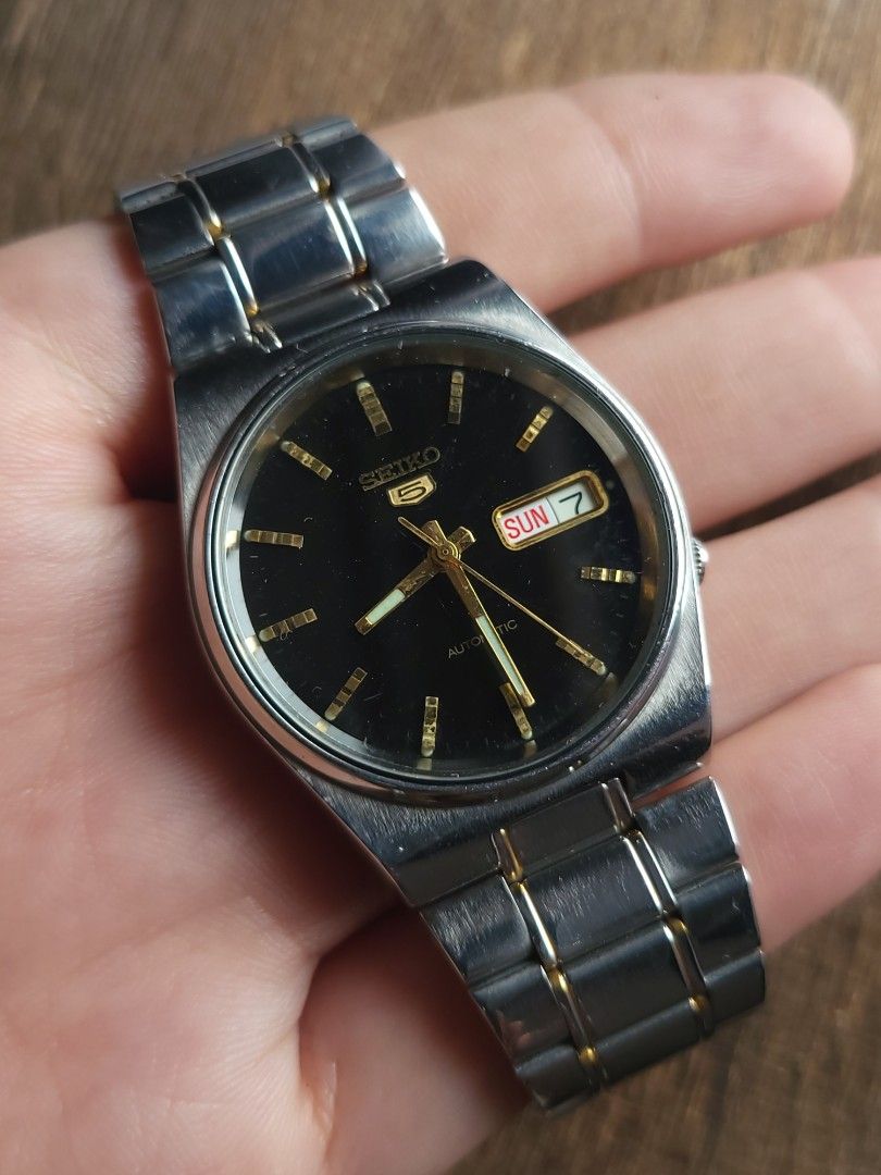 Vintage Seiko 5 Automatic Black Dial Men's Watch (Category: Men's Watches) located in Caloocan City. Submitted by oddstar_db4479 (Listing ID 1460455754, Image 1). Description: Seiko 5 Black Dial Gold Accents Integrated Bracelet Automatic (7S26-8160) Market Price : ₱6,500+‼️ Sale price : ₱2,999✅ Classic vintage integrated-bracelet case profile Original two-tone stainless steel bracelet Automatic Movement Japanese Caliber 7S26 (21 Jewels) Day & Dat