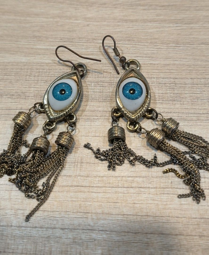 Vintage Solid Brass Evil Eye Earrings (Category: Earrings) located in Makati City. Submitted by fashion_thrift_ (Listing ID 1460437331, Image 1). Description: - Cool dangle earrings with an evil eye design. - Features multiple silver-tone chain tassels. - Unique statement piece to elevate any outfit. - Adds an edgy touch to your look. - Perfect for gifting or personal treat..