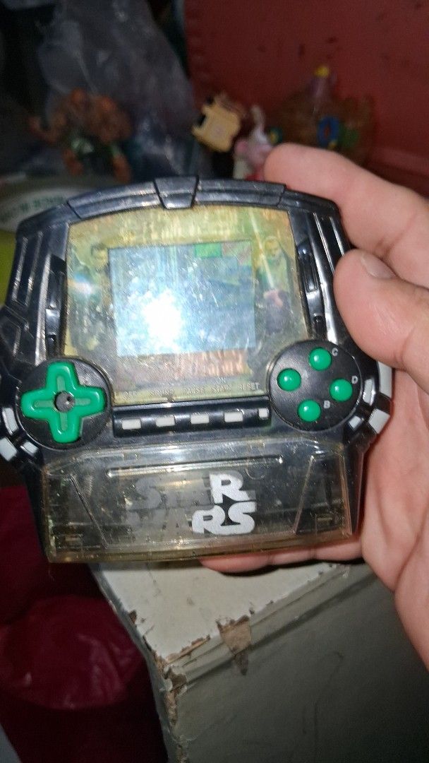 Vintage Star Wars Electronic Handheld Game with Figures (Category: Action & Battle Toys) located in Manila. Submitted by marcas022798212 (Listing ID 1460450944, Image 3). Description: - Vintage Star Wars electronic handheld game - Includes Darth Vader and Obi-Wan Kenobi figures - Features a game scene on the screen - Battery compartment visible - Kingever AA battery included for size reference - Ideal for Star Wars collectors and retro gaming ent