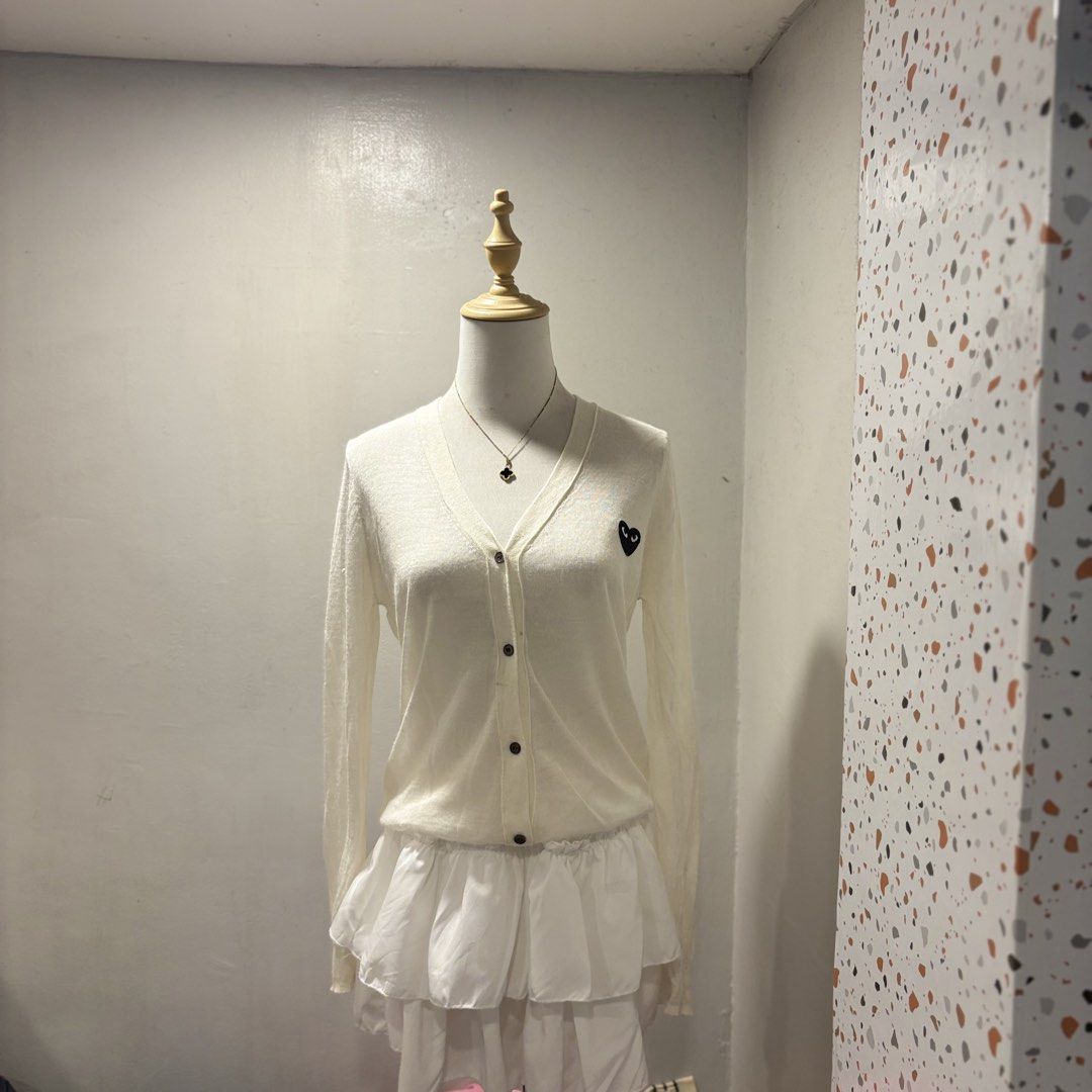 White Cardigan with Black Heart Logo (Category: Coats, Jackets and Outerwear) located in Mandaluyong City. Submitted by shopwithjuu (Listing ID 1460347344, Image 1). Description: Comme des Garçons Play white long-sleeved cardigan with iconic black heart logo. Button-up, lightweight knit. Perfect for layering..