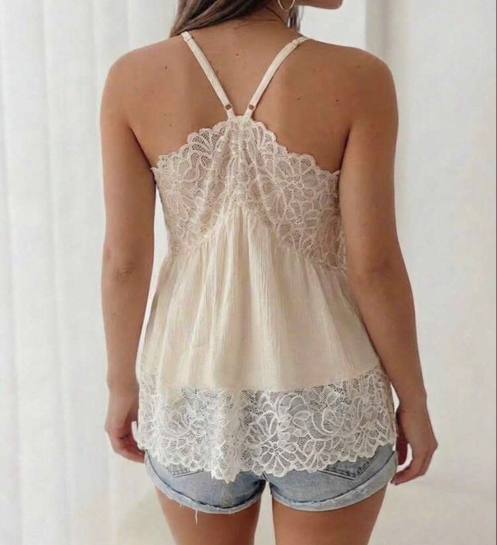 White Lace Trim Cami Top with Adjustable Straps (Category: Sleeveless) located in Caloocan City. Submitted by curateddepot (Listing ID 1460503525, Image 3). Description: - Cute white camisole top - Features delicate lace trim on neckline and hem - Adjustable spaghetti straps for a perfect fit - Lightweight and flowy material - Versatile: great for layering or wearing on its own - Pairs well with shorts or jeans.