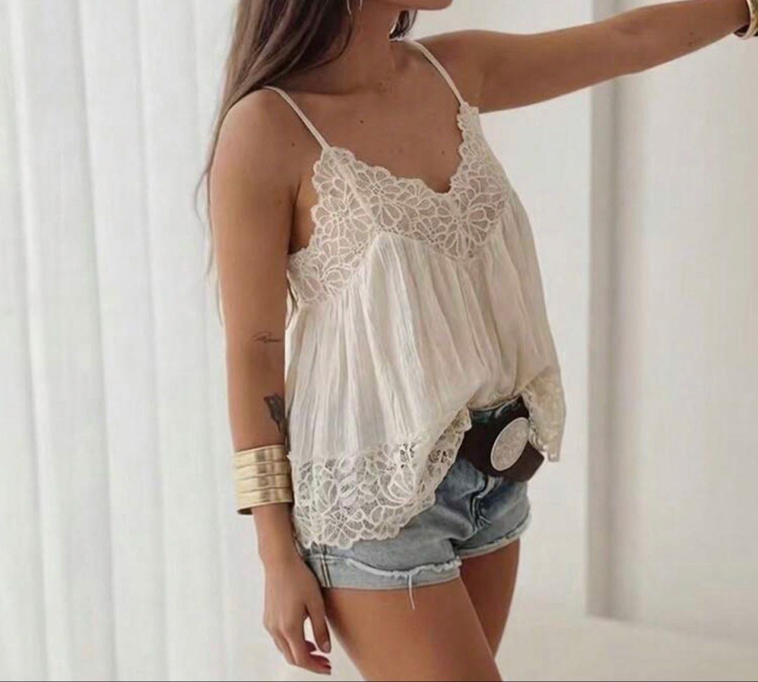 White Lace Trim Cami Top with Adjustable Straps (Category: Sleeveless) located in Caloocan City. Submitted by curateddepot (Listing ID 1460503525, Image 2). Description: - Cute white camisole top - Features delicate lace trim on neckline and hem - Adjustable spaghetti straps for a perfect fit - Lightweight and flowy material - Versatile: great for layering or wearing on its own - Pairs well with shorts or jeans.