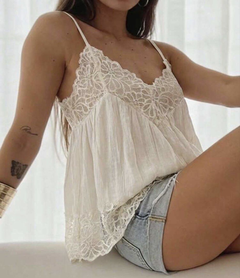 White Lace Trim Cami Top with Adjustable Straps (Category: Sleeveless) located in Caloocan City. Submitted by curateddepot (Listing ID 1460503525, Image 1). Description: - Cute white camisole top - Features delicate lace trim on neckline and hem - Adjustable spaghetti straps for a perfect fit - Lightweight and flowy material - Versatile: great for layering or wearing on its own - Pairs well with shorts or jeans.