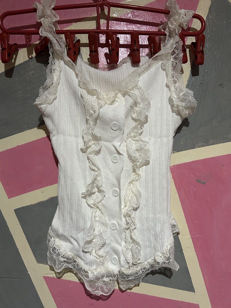 White Lace Trimmed Ruffle Button Up Bodysuit (Category: Others Tops) located in Manila. Submitted by prlvdbypau (Listing ID 1460397736, Image 1). Description: Free if you buy any some of my items - White ribbed bodysuit - Lace trim on straps and hem - Ruffle detailing down the front - Button closures - Super cute and dainty design - Ideal for layering or wearing on its own.