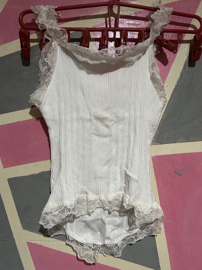 White Lace Trimmed Ruffle Button Up Bodysuit (Category: Others Tops) located in Manila. Submitted by prlvdbypau (Listing ID 1460397736, Image 2). Description: Free if you buy any some of my items - White ribbed bodysuit - Lace trim on straps and hem - Ruffle detailing down the front - Button closures - Super cute and dainty design - Ideal for layering or wearing on its own.