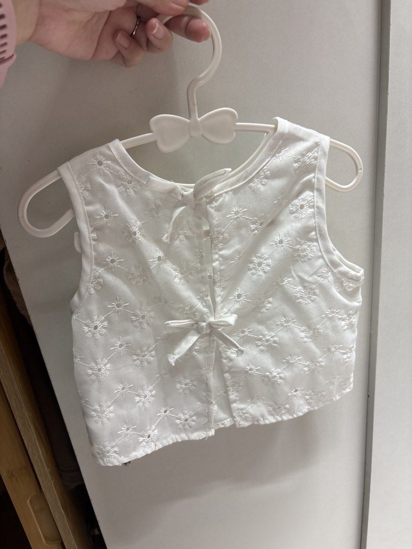 White Sleeveless Crop Top with Bow Back (Category: Babies & Kids Fashion) located in Quezon City. Submitted by sailormooooo (Listing ID 1460476130, Image 2). Description: - Adorable white sleeveless crop top - Features delicate all-over floral embroidery - Stylish button-up back with a tie detail - Best fits size Small to Medium - Ideal for creating chic summer outfits - Versatile piece, easily pairs with shorts or skirts.