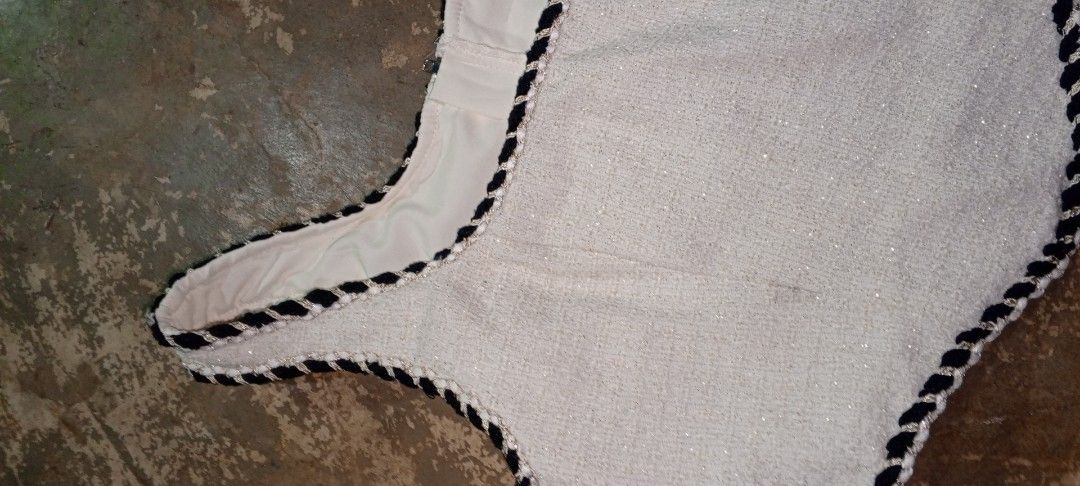 White Tweed Top with Black Trim (Category: Blouses) located in Manila. Submitted by ezekislacl02490 (Listing ID 1460421470, Image 2). Description: - White tweed sleeveless top - Black braided trim around neckline and armholes - Fully lined with smooth ivory fabric - Brand new with tag attached - Versatile for layering or wearing solo.
