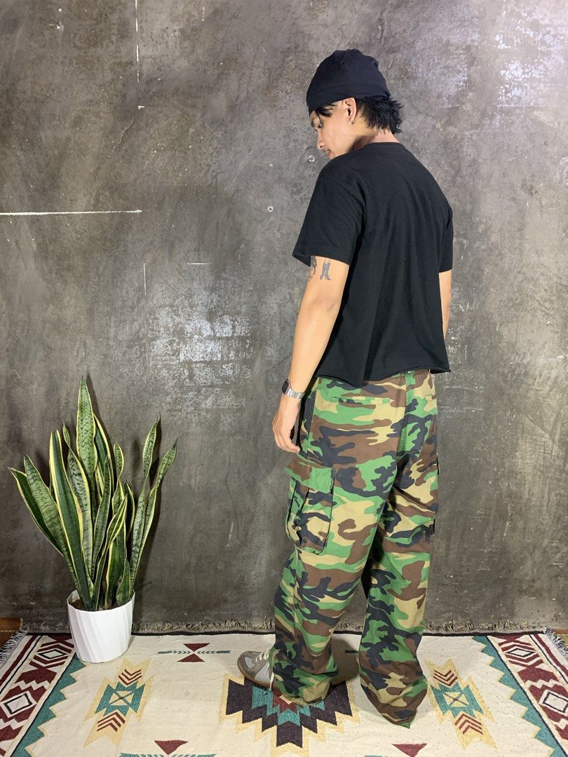 Wide Cargo Camouflage Pants (Category: Jeans) located in Aurora. Submitted by cpr_garments13 (Listing ID 1460475734, Image 3). Description: Models height 5’6 •Waist:33 •Thigh:13.5 •Length:40.5 •Leg opening:9.5 Excellent condition Replaced Button Need wash.