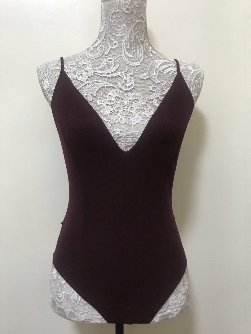 Windsor Burgundy Lace Back Zipper Bodysuit (Category: Others Tops) located in Manila. Submitted by airamef28.closet (Listing ID 1460424868, Image 1). Description: - Stunning burgundy bodysuit - Flattering deep V-neck front - Delicate spaghetti straps - Gorgeous circular lace panel on the back - Convenient zipper closure - Comfortable brief-style bottom - Versatile for layering or as a standalone piece.