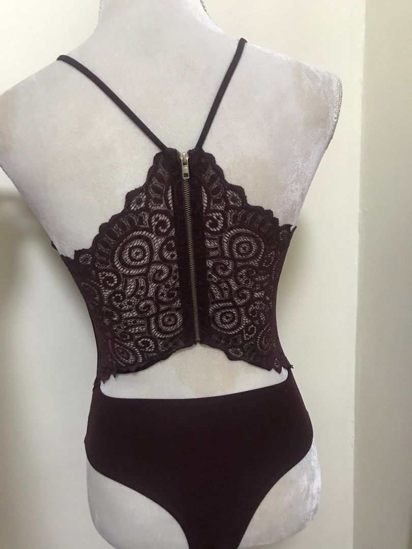 Windsor Burgundy Lace Back Zipper Bodysuit (Category: Others Tops) located in Manila. Submitted by airamef28.closet (Listing ID 1460424868, Image 2). Description: - Stunning burgundy bodysuit - Flattering deep V-neck front - Delicate spaghetti straps - Gorgeous circular lace panel on the back - Convenient zipper closure - Comfortable brief-style bottom - Versatile for layering or as a standalone piece.