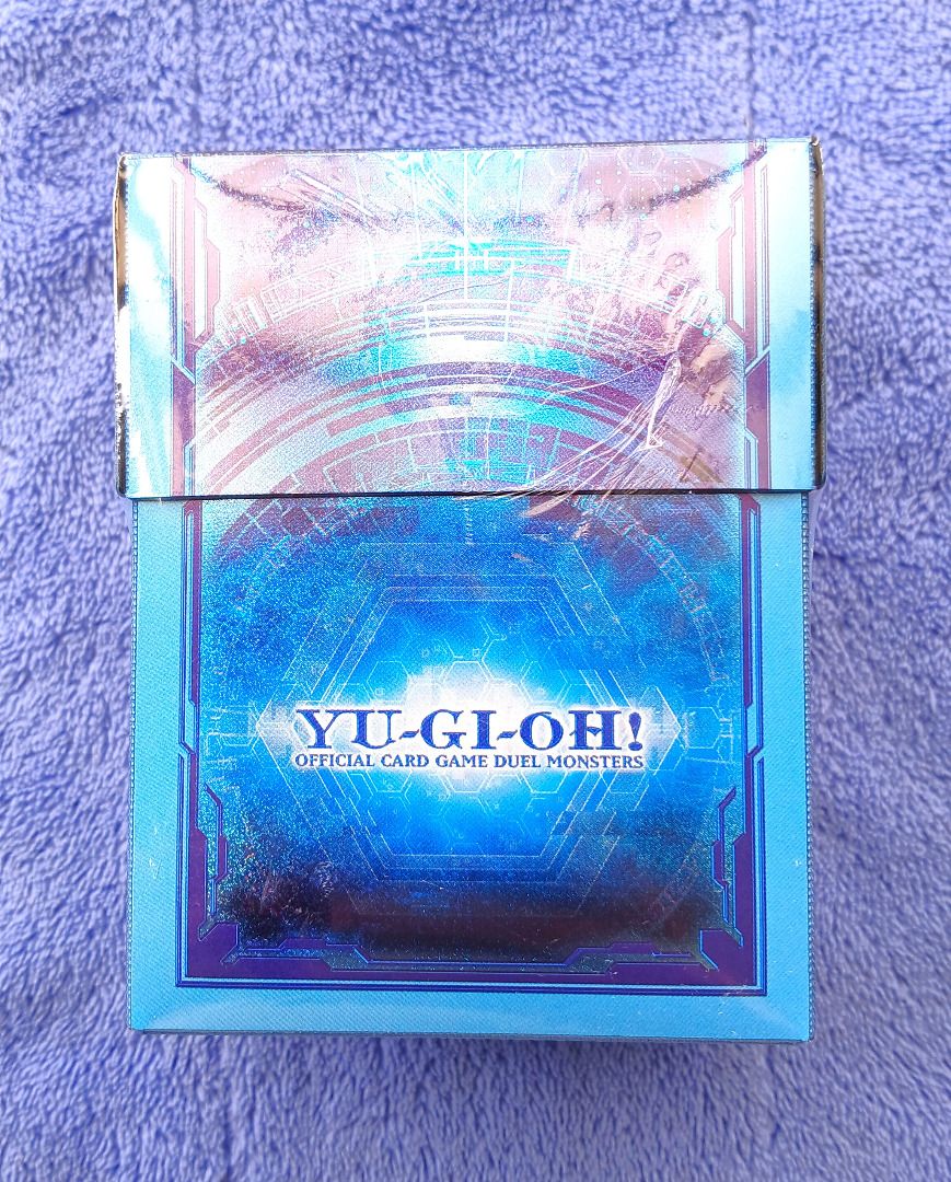 Yu-Gi-Oh Link Summon Special Duelist Card Case Deck Box (Sealed) (Category: Card Boxes & Cases) located in Iloilo. Submitted by jrmagallanes78 (Listing ID 1460328103, Image 1). Description: Official YuGiOh Prismatic Summon Duelist Deck Box with card divider (probably the thing shifting inside). Blue/light blue color scheme with holographic glitter effect on all sides. Items is still SEALED and UNUSED and in EXCELLENT condition with no readily vis