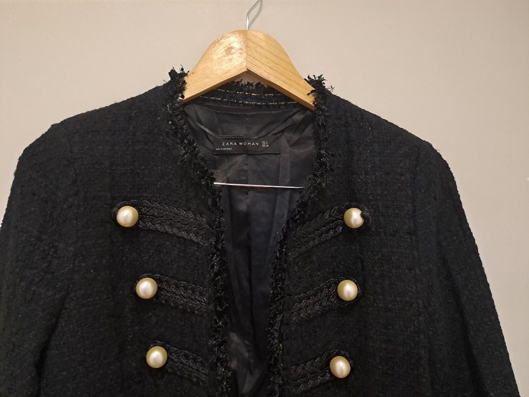Zara black tweed (Category: Coats, Jackets and Outerwear) located in Manila. Submitted by joanbalde39643 (Listing ID 1460477918, Image 2). Description: This item is an authentic Zara Woman black military tweed jacket featuring prominent faux-pearl buttons and frayed trim details. Design Features Material & Texture: Crafted from a mid-weight bouclé tweed with delicate frayed raw edges along the collarless opening and cuffs. Hardware: Outfitted wit