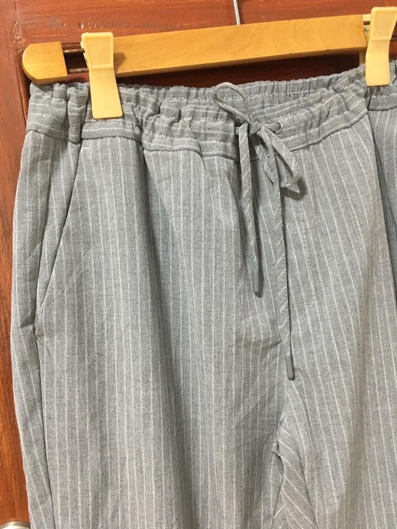 Zara Grey Pinstripe Drawstring Waist Pants (Category: Other Bottoms) located in Davao. Submitted by parenasnic86577 (Listing ID 1460435914, Image 2). Description: - Grey pants with subtle white pinstripes - Comfortable elastic waistband with adjustable drawstring - Two convenient side pockets - Relaxed fit for all-day comfort - Versatile for casual or dressed-up looks.